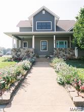 1 1/2 story home on corner lots. Lots 10, 11 and 12. 2988 sq. ft. of living area, full basement with roughed in full bath, 400 amp. service. Second floor separate electric furnace-2 1/2 ton AV, 50 gallon hot water heater, sump pump in basement with bake up electric pack. Covered front porch, cathedral ceilings, custom kitchen cabinets, stone fireplace in living room, large covered patio with stone fireplace. First floor 2184 sq. t.-second floor 804 sq. ft. Beautiful landscaping. Stamped concrete sidewalks. Hardie Board siding on residence with 2 car detached stone garage. This beautiful home is location in the heart of Owensville.