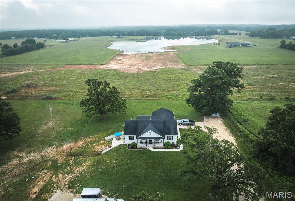 Beautifully crafted custom home on 10 scenic acres just outside of Cuba, Missouri. Built just five years ago, this stunning property offers the perfect blend of modern comfort, country charm, and convenience. Enjoy peaceful mornings and relaxing evenings from the screened-in porch overlooking the acreage and private pond. Equestrian enthusiasts will appreciate the thoughtfully designed, horse-ready setup featuring 10 acres of usable land with premium RAMM fencing throughout and steel safety self-latching gates. The impressive horse barn includes three 12' x 12' stalls equipped with high-quality Priefert sliding stall doors, electricity, and safe motor-enclosed fans in each stall. A frost-free water hydrant services the barn and stalls, while a separate hay and equipment barn provides additional storage and functionality. Two newly seeded pastures offer excellent grazing opportunities, and private well water serves the property. Beyond its equestrian amenities, this property is perfectly suited for a mini farm or hobby farm lifestyle, with plenty of room for animals, gardening, recreation, or simply enjoying the outdoors. The acreage provides privacy and room to roam while remaining just minutes from town and offering convenient access to I-44. Located in the heart of the Missouri Ozarks, this property is surrounded by outdoor recreation opportunities, including several conservation areas and state parks within 30 minutes for trail riding, hiking, and exploring. The nearby Meramec, Huzzah, and Courtois Rivers offer exceptional floating, fishing, and camping experiences. Cuba, known for its rich U.S. Route 66 history, colorful murals, antique shops, local restaurants, and small-town charm, adds to the appeal of this desirable location. Whether you're searching for a full-time residence, an equestrian property, a hobby farm, or a peaceful country retreat, this exceptional property offers a rare opportunity to enjoy the best of rural living with modern amenities.