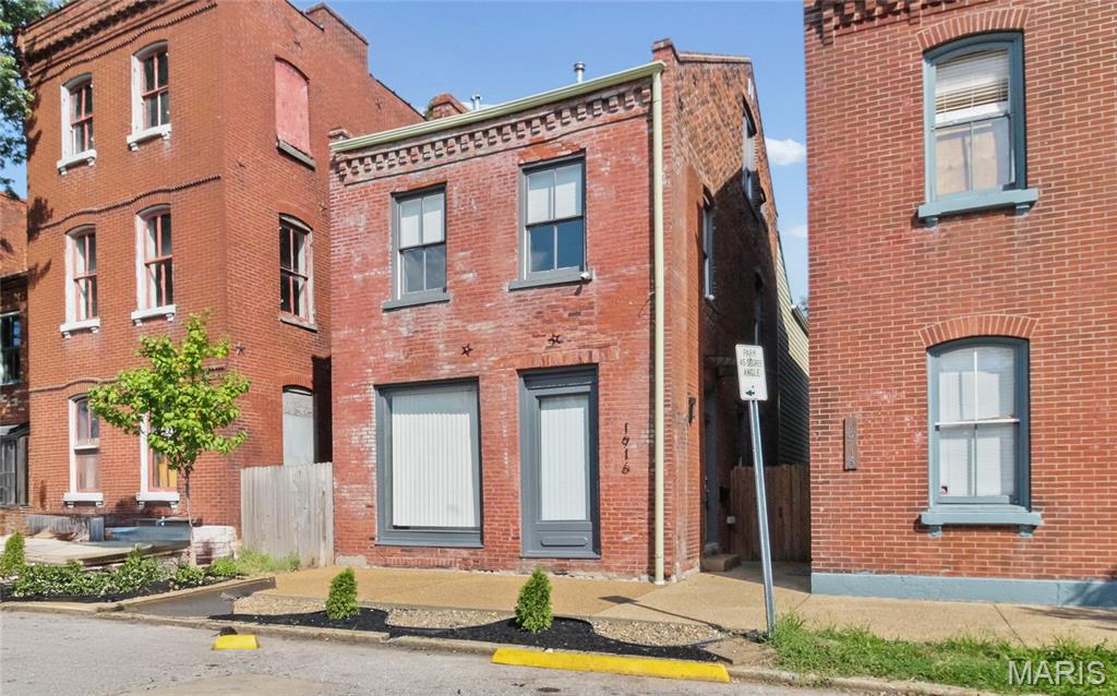 PRICE DROP & OPEN SAT 1-3PM! Soulard living at its BEST - one of a kind historic full gut rehab with outstanding finishes! One of St. Louis’ most vibrant and walkable neighborhoods. This beautiful three-story brick home has it all. Over 2,700 sqft, tall ceilings, two car covered parking, privacy fenced backyard, historic charm & modern upgrades - incl. newer roof with historic shingles, wood windows & 3/4 real hardwood flooring throughout. Step inside and you'll be greeted by an open concept layout with a large living room area and big front windows. Generous sized dining area flows to the gorgeous kitchen with a waterfall granite counter center island. Lots of cabinetry, coffee bar, stainless steel appliances incl. dishwasher, gas stove, refrigerator, a wine fridge and cabinet built-in microwave - a chef's delight! You'll love entertaining & hosting in this main living area. A main floor bedroom & full bath complete the first floor. Outside there's a huge back deck (perfect for patio set & bbq set up), a yard space for pets/ gardening and the carport. Valuable secured, off-street parking - a true luxury during Soulard’s famous events like Mardi Gras. Upstairs you'll find a HUGE primary suite featuring a large walk-in closet & a luxurious bathroom with double vanity, double shower and a soaking tub. Second level laundry area for convenience. Two spacious bedrooms with ample amount of closet space and the third full bath round up the second floor. Third level provides two bedrooms for multi-use: office space, work out/ hobby room, play area, guest room+++ Lower Level could be finished for additional recreation space while still function for storage & utility area. Thoughtful finishes throughout - this one is a MUST SEE. Enjoy walkability to some of the best bars & restaurants STL city has to offer!  Located just steps from iconic favorites like McGurk’s, Tucker’s, Molly’s, and the Soulard Farmers Market - this neighborhood is full of character, historic charm and a great community. CALL NOW