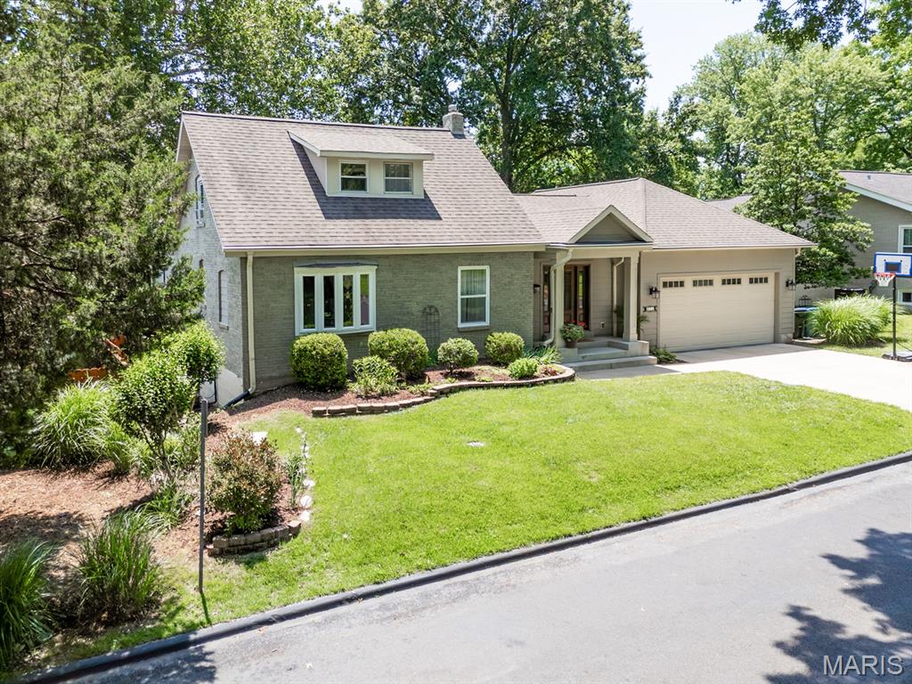 With major renovations and newer addition to this property, charm meets modern
convenience in this beautifully designed home. Step into the front foyer and original living room to see gleaming
hardwood floors throughout. Move on to be greeted by vaulted ceilings and
dramatic floor-to-ceiling windows in the great room, filling the space with natural light. The
great room offers a gas fireplace and opens to the custom chef’s kitchen. Here you will
find an abundance of custom cabinetry, a huge island with seating for four, and an ideal
layout for entertaining (all appliances stay). Sliding doors lead to a spacious deck
overlooking the meticulously landscaped 1/3-acre private lot. Outdoors, enjoy multiple
seating areas, a tranquil water feature, fire pit and thoughtfully selected foliage that
provides beauty and color throughout every season. Add the beautiful established trees
and you have your own private botanical garden! Down the hall is the main-floor primary
ensuite featuring a luxurious bath and walk-in closet and provides access to a private
deck. The main floor is completed by a Den/Library with gorgeous custom built-ins, stylish half bath and laundry room.
Upstairs you will find two additional bedrooms with ample closet space and a remodeled
Jack & Jill full bath with linen closet.
The finished lower level expands the living space with a large family room with a second
gas fireplace, bar area, bonus room, half bath and tons of storage with walk-out access to a
patio. Possible 4th bedroom in Den, lower level bonus room or work room w/ egress window. Come visit 890 Warwick Lane – your new home is waiting for you!