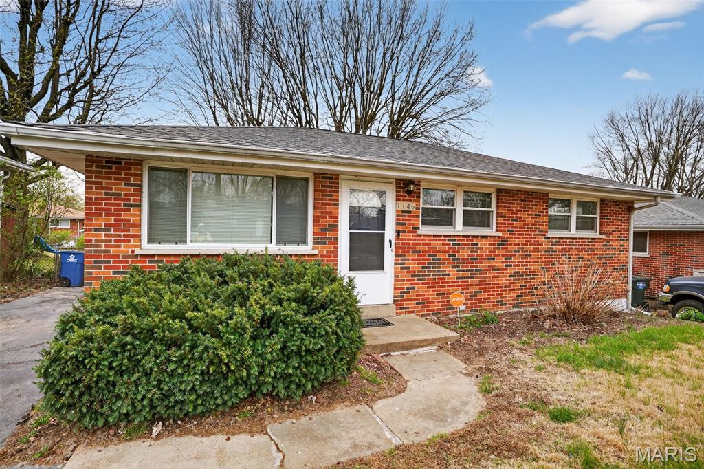 This residence is a classic 864 sq. ft. full-brick ranch home built in 1959, located in the unincorporated area of St. Louis County within the Hazelwood School District. The home features 3 bedrooms and 1 bathroom on the main level. Notable interior highlights include a living room with some wood flooring hidden under the carpet, ceiling fans throughout, and an eat-in kitchen equipped with a dishwasher. The property also includes a partially finished basement that provides a bonus family room and significant extra storage space.