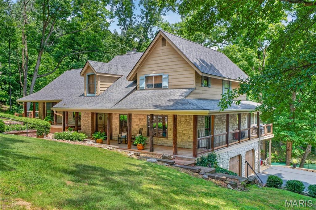 Escape to your own PRIVATE sanctuary with this CUSTOM 2-story home, nestled on nearly 4 acres of secluded woods in desirable Wildwood. The sprawling estate offers an unmatched country feel, complete with a tranquil, half-acre stocked pond and water feature. Enjoy total peace, quiet, and natural beauty only minutes from shopping, dining, and daily conveniences. 4 Bedroom, 3 full bath home featuring 3,000+/- SqFt, 2-car attached garage which connects to the Laundry Room under the main level with a Bonus Room & sliding glass door walk out. Antique barn wood, Cedar & Stucco wall accents/hardwood flooring throughout most of home. An expansive, covered wrap-around front porch welcomes you through double wood doors into an inviting entry foyer. Living room boasts a 24’+/- vaulted ceiling w/wood panels & beams, floor-to-ceiling stone wood burning fireplace, freestanding antique wood stove, built-in shelving & a wall of windows w/2 sliding glass walk-outs allowing plenty of natural light & scenic views of the property/pond. Kitchen offers custom cabinetry, granite countertops, brick backsplash, center island, Rangemaster range hood, 2 pantries & breakfast bar to Dining Room. Dining room, full bath & screened-in porch complete the main level. Upper level extends living quarters with 2 bedrooms, hall full bath & primary suite with bay window, 2 French door closets, built-in shelving & ensuite full bath with tile flooring, custom double sink vanity, custom shower, built-in shelving & linen closet. Separate open split-level steps up to a spacious recreation room that features 10’+/- ceiling, carpet, freestanding antique wood stove, dry bar, walk-out to side deck & expansive views of the property. Walk-out lower level features a 4th bedroom, bonus room, laundry/utility room, & an additional recreation room w/sliding glass walk-out to covered patio. Unfinished storage room for additional storage space. Don't miss out—schedule your private tour today! :)