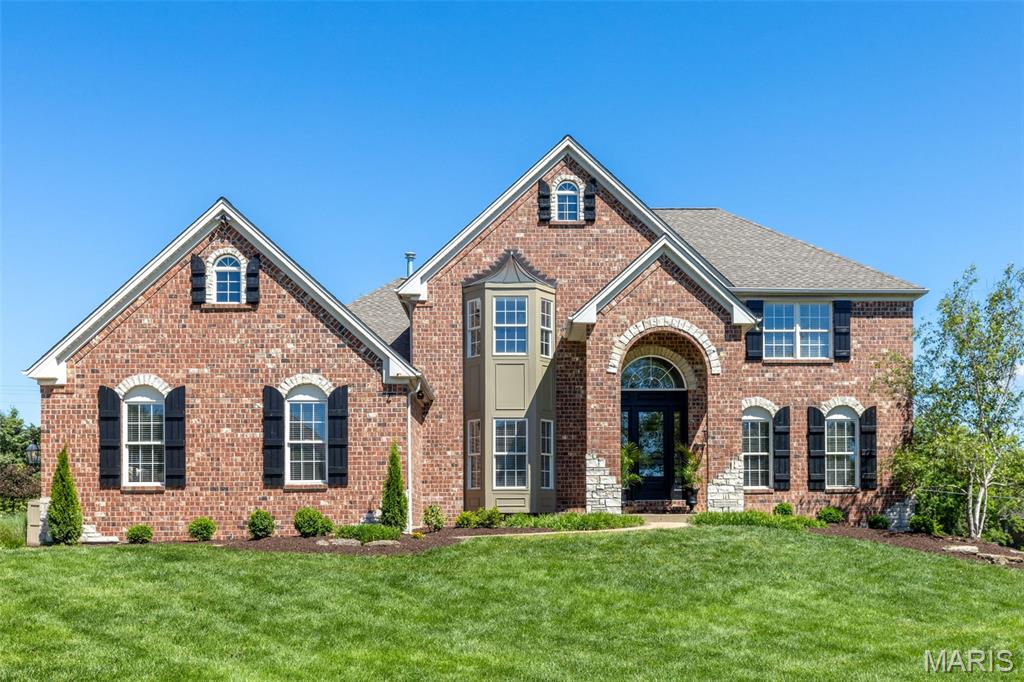 This beautifully designed 1.5 Sty from Claymont Development features a brick & stone elevation & dramatic arched porch entrance to create amazing curb appeal. Impressive 2-sty foyer leads to private study surrounded by natural wood paneling & bookcases, elegant dining room and stunning great room with floor-to-ceiling fireplace flanked by 2-sty Palladian windows. Designer kitchen with 42” bisque cabinetry, granite countertops, stainless steel appliances, 7’ center island & convenient planning center adjoins breakfast room with wide bay window & hearth room highlighted by brick fireplace. An ensuite bedroom completes the main floor living quarters. Oak staircase accesses primary bedroom suite with luxury bath plus 2 additional bedrooms with Jack n’ Jill bath. Lower-Level entertainment space includes recreation room with large gathering bar, family room & full bath with steam shower. Atrium door opens to outdoor living area with patio with hot tub & pool surrounded by landscaped gardens.
