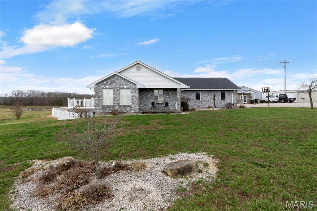 This isn't just a home, it's a lifestyle. Nestled on 3.13 acres in Perry County, this custom all-brick ranch has been built and finished to a standard you won't find at this price anywhere else in SE Missouri. Step inside to handcrafted custom cabinetry and rich woodwork throughout. Head downstairs to the finished walkout basement with a full bar,  it opens directly to the in-ground pool and composite deck, making entertaining effortless. Outside: a serene pond stocked with bluegill and bass, a cabana, and a 4,800 sq ft shop with heated floors and a mechanic's pit. The property even has its own internet tower providing free internet service. Whether you're a car enthusiast, a hobbyist, someone who loves to entertain, or simply someone who wants true privacy without sacrificing quality, this is it. Properties like this don't come around twice.