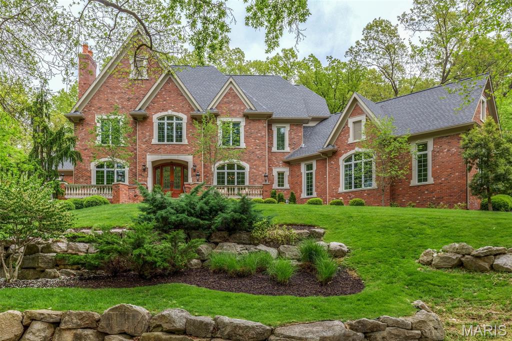 Magnificent 8507 sf Estate home on 3+ scenic acres. This DeShetler-built 1.5 Sty features superb craftsmanship & distinctive architectural elements throughout. 2-Sty marble foyer highlighted by dramatic curved staircase leads to library-paneled study with built-in bookcases & fireplace, elegant dining room & stunning great room with marble fireplace & 2-sty bow window. State-of-the-art kitchen with buff cabinetry, Taj Mahal quartzite countertops, commercial grade appliances & butler’s pantry adjoins breakfast room, hearth room with floor-to-ceiling stone fireplace & gathering bar. Coffered primary bedroom suite with marble bath with jetted tub provides an appealing retreat. Front & rear staircases access 3 additional ensuite bedrooms & bonus room. Walk-out Lower Level includes recreation room with entertainment center & fireplace, billiards room, fitness studio, sunroom, 2nd kitchen & full bath. Tucked away in a perfect location with patio, infinity pool, rock garden with waterfall & 4-car garage.