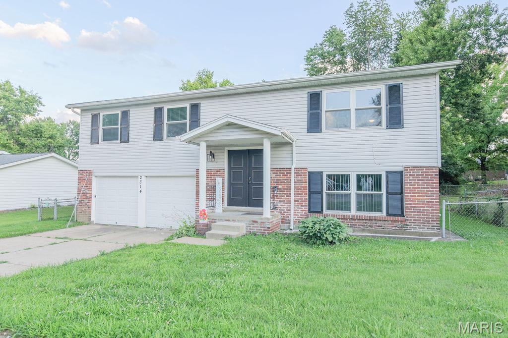 Charming and refreshed split-level home on a quiet Florissant street offers comfortable living with modern updates. This well-maintained residence features a newly remodeled bathroom, new flooring throughout, fresh neutral paint, bright living spaces, and a practical layout that flows from the living room to the kitchen and bedrooms. The lowel level features a large laundry and utility room, a large recreation space, and a private room for the home office, crafting lair, pet reatreat or sleeping area of your dreams!!  The lower level has exits to the rear yard and the attached oversized two-car garage which provides convenient parking and extra storage, while the private backyard with large attached deck is ideal for outdoor entertaining and everyday relaxation.  With easy access to I-270, I-170, and Route 67 for convenient commutes across the St. Louis area. A move-in ready option for families, roommates, or anyone seeking a well-priced home in a central Florissant location.