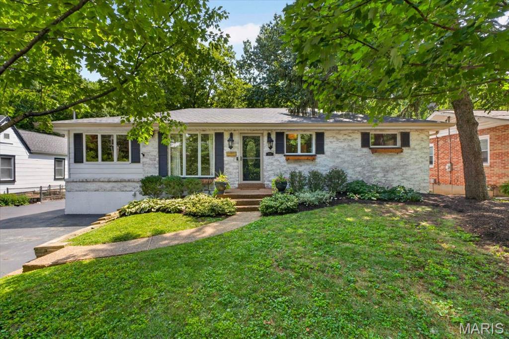 Welcome to this charming Rock Hill ranch offering almost 2,000 square feet of finished space inclusive of the basement. Timeless character, thoughtful updates, and a beautifully landscaped backyard create a warm, welcoming setting both inside and out. Hardwood floors, custom millwork, and arched doorways add flow throughout the main level. The inviting living room features a large picture window and flows into the dining area and spacious kitchen, complete with custom cabinetry, granite countertops, stainless steel appliances, a breakfast bar, and backyard views with deck access. Two bedrooms and a full bath complete the main level. The finished lower level offers additional living space with a large recreation room, laundry, and ample storage. Outside, enjoy the expansive deck overlooking the tree-lined backyard with large storage shed —a peaceful retreat. Ideally located in Rock Hill with convenient access to shopping, dining, parks, and major thoroughfares, this well-maintained home offers character, comfort, and an exceptional setting.
