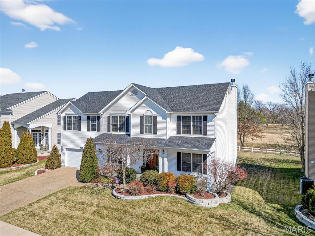 Backing to the 15th fairway with beautiful sunrise views, this spacious 2-story home offers over 3,100 sq ft in the highly sought-after Villages of Dardenne. Great curb appeal with professional landscaping and a stylish front door welcomes you inside to wood flooring, an open floor plan, and spacious rooms. The kitchen features 42" cabinets, stainless steel appliances, and a large center island with granite top. The breakfast room and great room both have bay windows with golf course views, and the great room includes a cozy wood-burning fireplace. Main level also offers a private office, formal dining room, updated half bath, and large laundry area. Upstairs you’ll find a spacious primary suite with two walk-in closets and luxury bath with dual sinks, tub, and separate shower. Three additional bedrooms, a bonus family/loft area, and plenty of closet space complete the upper level. Neighborhood amenities include 3 pools, tennis courts, walking trails, and clubhouse. Rare opportunity for golf course living!