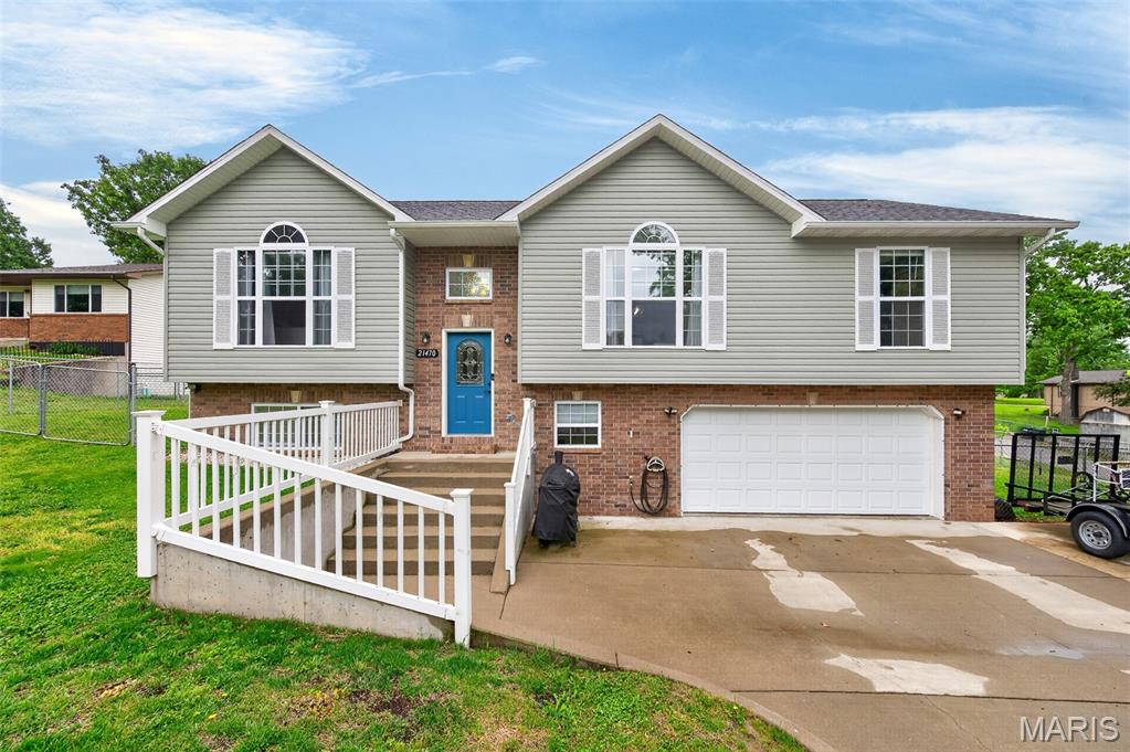Welcome to 21470 Sail Rd! This well-appointed home offers generous living space and standout features throughout. The kitchen is designed to impress with granite countertops, tile backsplash, wood flooring, range top, and double wall ovens. Arched doorways and updated lighting, paired with updating flooring highlight how this home is dressed to impress! Retreat to the oversized primary suite complete with separate his and hers closets, vaulted ceiling, plant shelf and palladian window. The lower-level family room creates the perfect space for relaxing or entertaining, while the dedicated laundry room keeps daily living organized. Enjoy the benefits of a large garage, additional parking to the side of the driveway, and a fenced corner lot offering both space and privacy. Conveniently located in off the beaten path in the Forest Hills subdivision in Waynesville, minutes from downtown, I-44 and the Fort, without sacrificing privacy.
