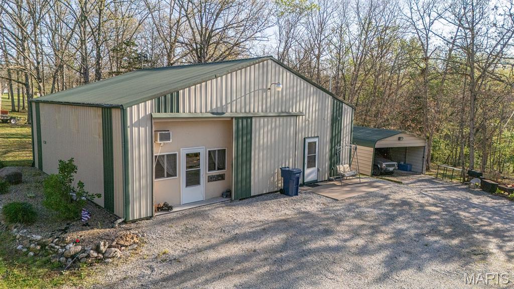 Look at this incredible setup in the Mark Twain Lake area, located approximately 6 miles from Spalding Beach and the boat ramp! This 2015, 4-bedroom, 1-bath home with a loft area sits on 2.8 park-like acres in the established Villa De Woods subdivision. The family room features reclaimed barn wood from an old barn, adding warmth and character to the space. The home offers FAE heat and central A/C, and a front sliding door that can fully close off the front of the home. The exterior is well-suited for entertaining, storage, and lake life, with ample room for campers, trailers, and guests on a large, graveled area at the end of a dead-end road.

Improvements include:
30 ’x 40’ outbuilding with electric and gravel floor
18’ x 22’ x 9’ carport pavilion with electric
8’ x 48’ storage container with electric
18’ x 30’ three-sided carport with electric
18’ x 32’ x 12’ carport with concrete slab covering a camper that conveys
Multiple RV hookups

Additional features include a fire pit, a designated area for an above-ground pool, a wet-weather stream, and so much more.  Simply too much to list — come take a look!