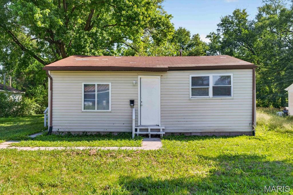 Discover the potential of this single-story ranch-style home located at 811 Sparks Ave in Cahokia, IL. Currently vacant and ready for immediate marketing, this property offers a straightforward layout and classic exterior, making it an excellent opportunity for investors, renovators, or homeowners looking for a project to make their own.

The exterior features neutral-toned horizontal siding complemented by a durable brown roof and trim. The front entrance includes a white wooden porch and steps leading to a clean white front door. Large front-facing windows provide ample natural light while installed blinds offer privacy.

Inside, the main living area features cozy dark brown carpeting, light-colored walls, crisp white baseboards, and an attractive arched doorway that creates a defined yet open transition into the rest of the home. The kitchen includes white cabinetry, a double stainless-steel sink positioned beneath a bright window, practical wood-look laminate flooring, and square ceiling tiles. The full bathroom features a white vanity with integrated storage, a dark wood-framed mirror, and a classic bathtub with a full white surround. A dedicated utility and laundry room provides tile flooring equipped with full electrical washer and dryer hookup!