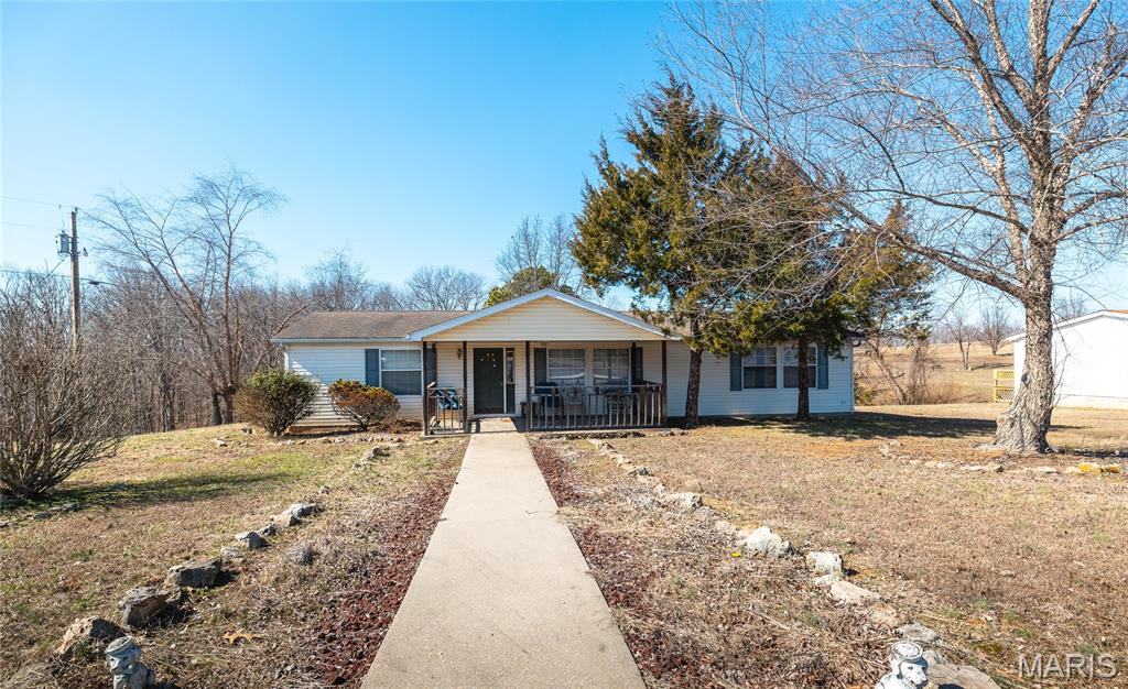 Experience the charm of affordable country living with this 3-bedroom, 2-bath manufactured home nestled on 3 +/- acres with shared pond access. Ideally located just off State Highway 51, this property combines easy accessibility with the quiet comfort of a rural setting. The open acreage offers plenty of space for outdoor enjoyment, entertaining, or simply unwinding while taking in the peaceful views. Whether you're searching for a place to call home or a relaxing getaway from the hustle and bustle, this property delivers a wonderful combination of privacy, convenience, and value.