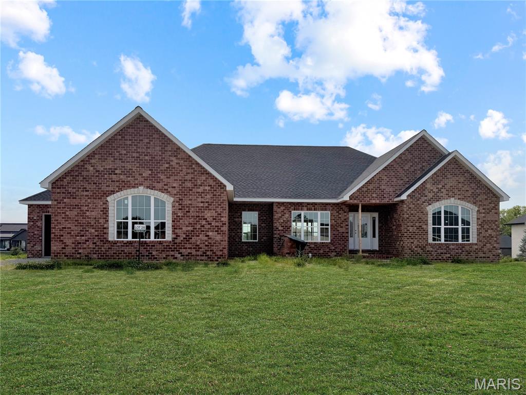 Experience luxury and convenience at 1383 Walnut Ridge in Columbia, IL. This quality built NEW CONSTRUCTION home has 3 bedrooms, 2.5 baths and is absolutely exquisite with 2,600+ square feet, 3 side brick home showcases an oversized 3 car side entry garage. Inside this estately 1 story home, the living room boasts a vaulted ceiling and gas fireplace framed by a floor-to-ceiling stone hearth. Dining room or home office as you enter front door offers lots of opportunity. Chef-ready kitchen features cotton white cabinetry with crown molding, stainless steel appliances, solid surface countertops, a center island, and walk-in pantry. Main-floor primary suite is a sanctuary, featuring nine-foot ceilings, tray ceiling with recessed lighting, a spacious walk-in closet, and an attachede primary bathroom with a double-bowl vanity, separate shower, and soaking tub. There is also direct access to the main floor laundry room from the primary bath. Core-Tec Luxury Vinyl Plank throughout entire main floor. 2 panel interior doors throughout.  9' ceilings on main floor. Step outside to a covered composite deck—complete with vinyl railing, steps to walkout basement, ceiling fan and recessed lighting and electrical for an outdoor TV—perfect for savoring sunset views. The deck can be screened in (additional cost) to maximize comfort during summer months. Walk-out basement with 9' pour and egress windows offers the option to create a fourth and fifth bedroom or additional living space before closing. Located just 5 minutes from Historic Main Street with restaurants, shopping, and community events. Easy highway access to St. Louis, this move-in-ready home provides an easy commute to Scott Air Force Base, STL International airport and nationally renowned hospitals and medical care. Don’t miss your opportunity to own this gorgeous home with luxury finishes & unbeatable location!!