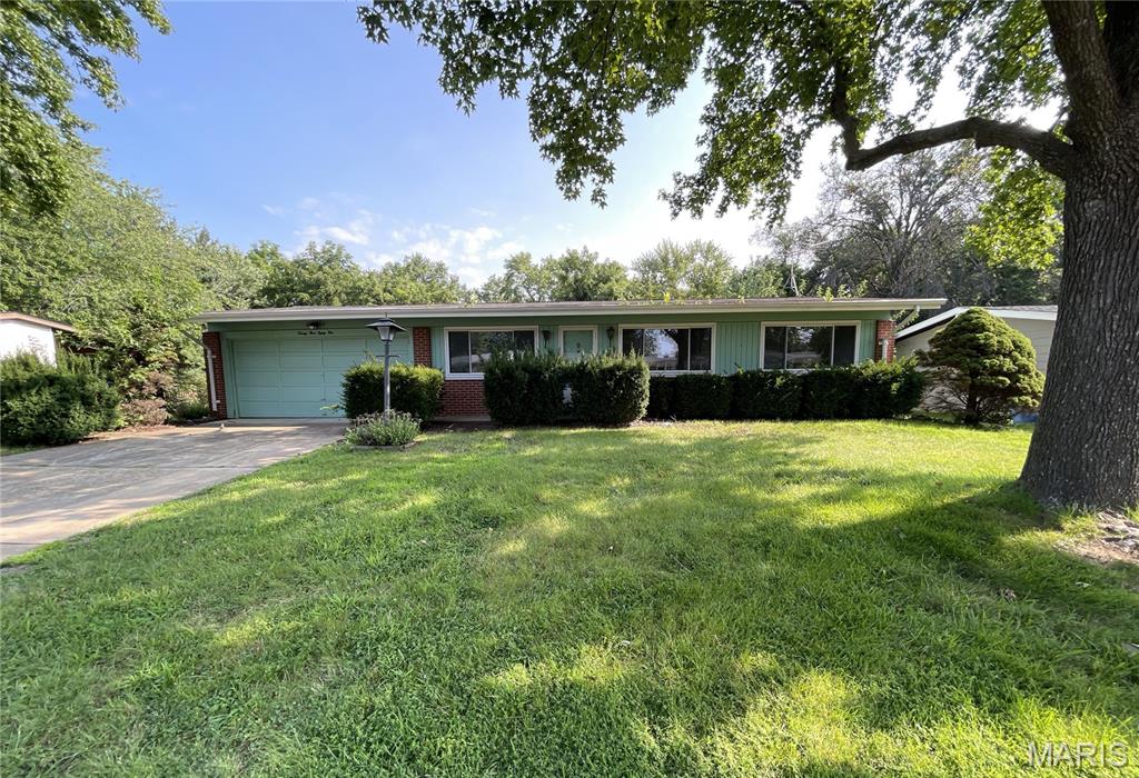 FINISH THIS PROJECT! Discover the potential in this charming 3-bedroom, 1.5-bathroom home situated on a large lot in the Paddock Hills neighborhood. Offering approximately 1,160 square feet on the main level, this home features mid-century charm with updates already underway. The main floor offers a comfortable living room, spacious bedrooms, a kitchen with partially updated white shaker cabinets and white granite countertops, and tiled bathrooms. Original wood floors add character, while large vinyl windows bring in plenty of natural light. The partially finished basement provides additional flexibility with a den, bonus room, and a large area for storage. A two-car attached garage adds convenience. Outside, the large lot includes a storage shed that complement the home. Located with easy access to shopping, schools, and Lindbergh Road. The location provides convenient access to everyday amenities, transportation routes, and surrounding areas. This is a cute, charming house with plenty of potential. Take over this project and bring your vision to life!