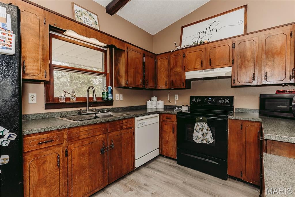 Full of charm, character, and thoughtful updates, this inviting 3-bedroom, 2-bath home offers the perfect blend of comfort, space, and convenience on 1.5 beautiful acres!
Step inside to an open main living area featuring vaulted ceilings and a beautiful stone fireplace that creates a warm focal point extending into the dining space. This home is move-in ready while still offering plenty of opportunity to add your own personality.
Start your mornings with a cup of coffee on the large covered front porch, where peaceful wooded views and frequent wildlife sightings create the perfect place to relax, unwind, or entertain guests. Out back, you'll find a fenced yard ideal for pets, play, or gardening, along with an equipment shed that provides excellent space for storage, hobbies, or projects.
Need extra space? The unfinished basement offers endless potential for storage, a workshop, future living space, or whatever fits your needs. Additional features include a 2-car garage and plenty of room both inside and out to make yourself at home. Conveniently located just 5 minutes from local restaurants, a coffee shop, grocery stores, parks, and a golf course, with an easy commute to Fort Leonard Wood, St. Robert, and Rolla.
This is the kind of home that combines peaceful country living with everyday convenience—don't miss your chance to see it!