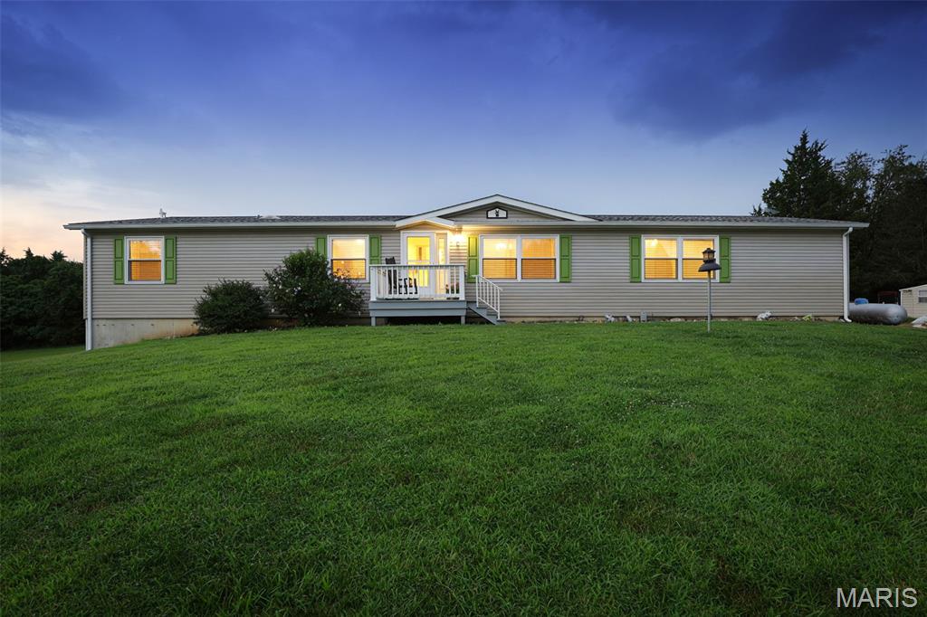 Where privacy, beauty, and modern comfort come together—This beautiful 4-bedroom, 3-bath retreat sits on 10 breathtaking acres complete with a picturesque pond, mature trees, and beautifully landscaped grounds. Thoughtfully maintained and tastefully updated, this spacious home offers the perfect blend of comfort, elegance, and country charm. Inside, you'll find generous living spaces with new living room and kitchen flooring installed in 2026, creating a fresh, welcoming atmosphere for everyday living and entertaining. Step outside and discover the true showstopper—an expansive covered deck overlooking the serene property, hot tub, offering the perfect backdrop for morning coffee, sunset gatherings, or simply soaking in the beauty and privacy of your surroundings. The level acreage provides endless opportunities to roam, relax, or create your dream outdoor lifestyle. Recent improvements include a new roof, AC system, dishwasher, gutters, and windows in 2025, giving buyers peace of mind and modern efficiency. From the tranquil pond and towering trees to the thoughtful updates throughout, this exceptional property offers the rare opportunity to own your own private slice of paradise.