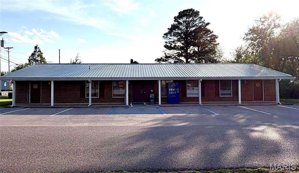 Discover 2,886 square feet of prime commercial space in the heart of Sullivan, set on a spacious 0.28-acre lot. Strategically located on historic Route 66, this property boasts high traffic and unparalleled visibility, making it an ideal investment for your business. Zoned C3, this property has undergone recent upgrades, including a newly installed metal roof and modern vinyl flooring, along with other enhancements. The central area offers an expansive open space perfect for retail or office use, complete with a front counter, a large office, and a breakroom equipped with kitchen facilities and a bathroom. Each end of the building includes two separate areas, each with its own entrance and bathroom, providing the opportunity to divide the property into three distinct spaces. The property is equipped with a robust HVAC system featuring an air scrubber and a mini-split unit on the north end, ensuring comfort and air quality. With a brick exterior on three sides, the building is designed to be relatively maintenance-free. Wired for high performance, this building is ready to support your business needs. This sale includes the building and the surrounding ground, offering an outstanding opportunity for businesses seeking a central and highly visible location. Don’t miss the chance to establish your business in this exceptional property.