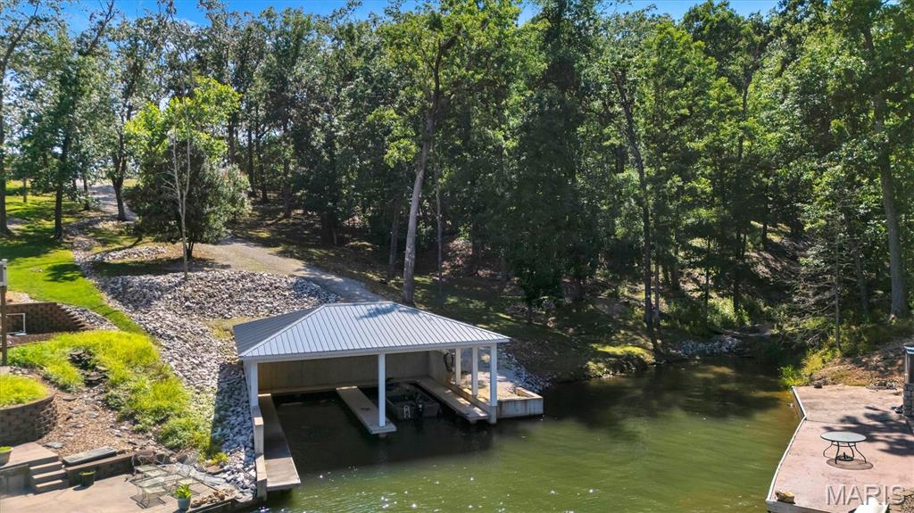 Premium Lakefront Lot in Quiet Cove with Private Double Covered Boat Dock at Lake Perry! The Ultimate Waterfront Canvas: Build Your Dream Retreat in Missouri's Premier Gated Lakeside Community. Rarely does an opportunity emerge to secure a prime waterfront homesite in the highly coveted, private gated community of Lake Perry. Positioned perfectly on the water’s edge, this premium lakefront lot comes completely turnkey for summer fun and is ready for your architectural masterpiece. Skip the wait and expense of building infrastructure—this property features a rare, private double covered boat dock, providing immediate water access, boat protection, and the perfect launching pad for a lifestyle centered around the water. Whether you are looking to design a permanent luxury lake estate, a weekend cabin retreat, or anchor a stunning secondary home, this lot delivers a perfect blend of natural privacy and premium convenience. Utilities are readily accessible, drastically simplifying your building timeline. True Waterfront Positioning: Generous shoreline ownership with direct, unobstructed access to the crystal-clear waters of Lake Perry. Premium Double Covered Boat Dock: A highly valuable infrastructure asset featuring dual covered slips to keep your watercraft secure from the elements, alongside plenty of space for lakeside lounging. Prepared Homesite: Exceptional topography offering optimal vantage points for panoramic water views, ready for your custom floor plan.The Gated Experience: Total peace of mind with 24/7 controlled gate security, protecting your privacy and your investment. Experience the Unmatched Lake Perry Lifestyle:As a lot owner, you gain full access to the rich array of private amenities that define Lake Perry’s resort-style living:The 200-Acre Spring-Fed Lake: Pristine, crystal-clear water ideal for high-speed boating, tubing, water skiing, kayaking, and exceptional crappie and catfish fishing. Enjoy holiday fireworks, community activities such as chili cook-offs, fishing derbies, trivia nights, food trucks and more! Plus spectacular nightly stargazing! Resort Amenities: Spend your days enjoying the community’s sparkling swimming pool, expansive sandy beaches, sand volleyball courts, and modern playground facilities. Convenience & Community: Features a dedicated marina loop, on-site seasonal dining/food trucks, public pavilions for large gatherings, and convenient shower/laundry houses. The Setting: Nestled within 1,800 acres of lush hardwood forest right next to the Mark Twain National Forest, ensuring abundant wildlife, eagle sitings, and unmatched tranquility. The Area & Location: Perfectly balanced between secluded and connected, Lake Perry is located just minutes southwest of historic Perryville, and easily accessible from Interstate 55. You are just a short drive from the award-winning boutique wineries of Ste. Genevieve, excellent local dining, and comprehensive shopping—making it an effortless commute from both the St. Louis metro area and Cape Girardeau. Waterfront lots with pre-installed double covered docks are nearly impossible to find in today's market. Don't wait to start building your legacy of lakeside memories. Schedule your private, agent-guided tour through the security gates today!