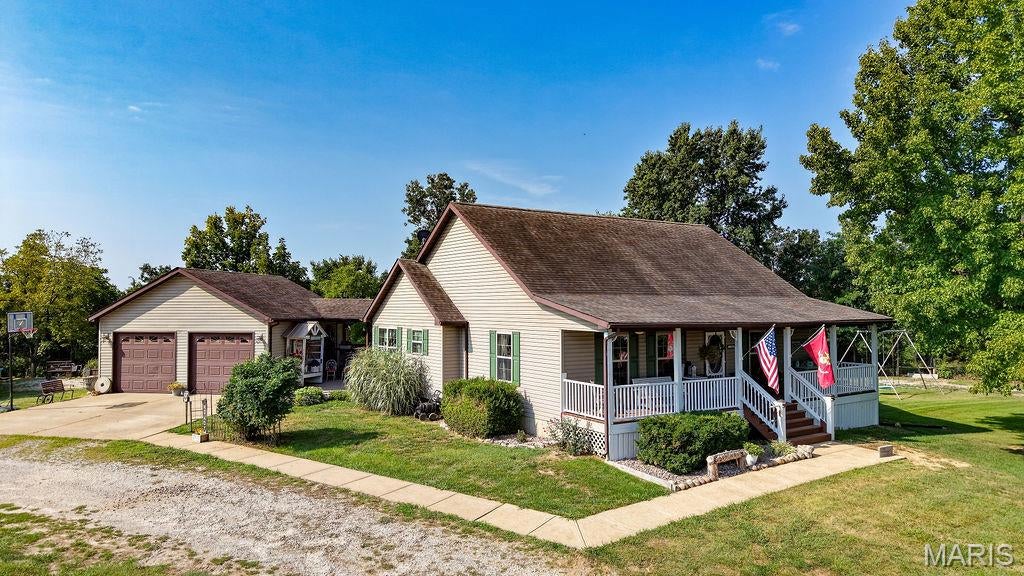 **IN-LAW QUARTERS, ACREAGE & AN INSULATED POLE BARN WITH ELECTRIC—THIS ONE HAS IT ALL!** If you're looking for a home with flexible living space and room to spread out, you've found it! This impressive 4  bedroom, 3-bath home with an additional 4th bedroom in the lower level** sits on **1 beautiful acre** just minutes from town while offering the peace and privacy of country living.

You'll love the **huge covered front porch**, perfect for relaxing and adding your own personal touches. Inside, the spacious yet cozy great room welcomes you with beautiful hardwood floors and flows into the large eat-in kitchen featuring an abundance of cabinetry and all kitchen appliances. The main level offers **3 spacious bedrooms, each with a walk-in closet**, plus **2 full bathrooms and convenient main-floor laundry** just off the kitchen.

The lower level offers an incredible **complete apartment/in-law suite** with a living area, kitchen area, separate bedroom, and full bathroom, plus plenty of additional storage. The **atrium-style walk-out** is truly a showstopper, with a completely enclosed space surrounded by windows that brings in tons of natural light. A separate driveway leads directly to the lower-level entrance, providing privacy and convenience.

Outside, the possibilities continue with an insulated 30x40 pole barn with electric, plus a 2-car garage attached by  covered walkway leading directly to the kitchen, spacious deck, and an amazing patio perfect for entertaining or relaxing outdoors
The **AC was replaced just one month ago**, and the sellers have completed a full septic inspection and made the recommended repairs, with documentation attached.

Whether you need **in-law quarters, a private space for an adult child, guest accommodations, a home office, or potential short-term rental space**, this property offers incredible flexibility. Enjoy the best of both worlds—**beautiful country surroundings with no HOA fees, yet just minutes from shopping and town!**