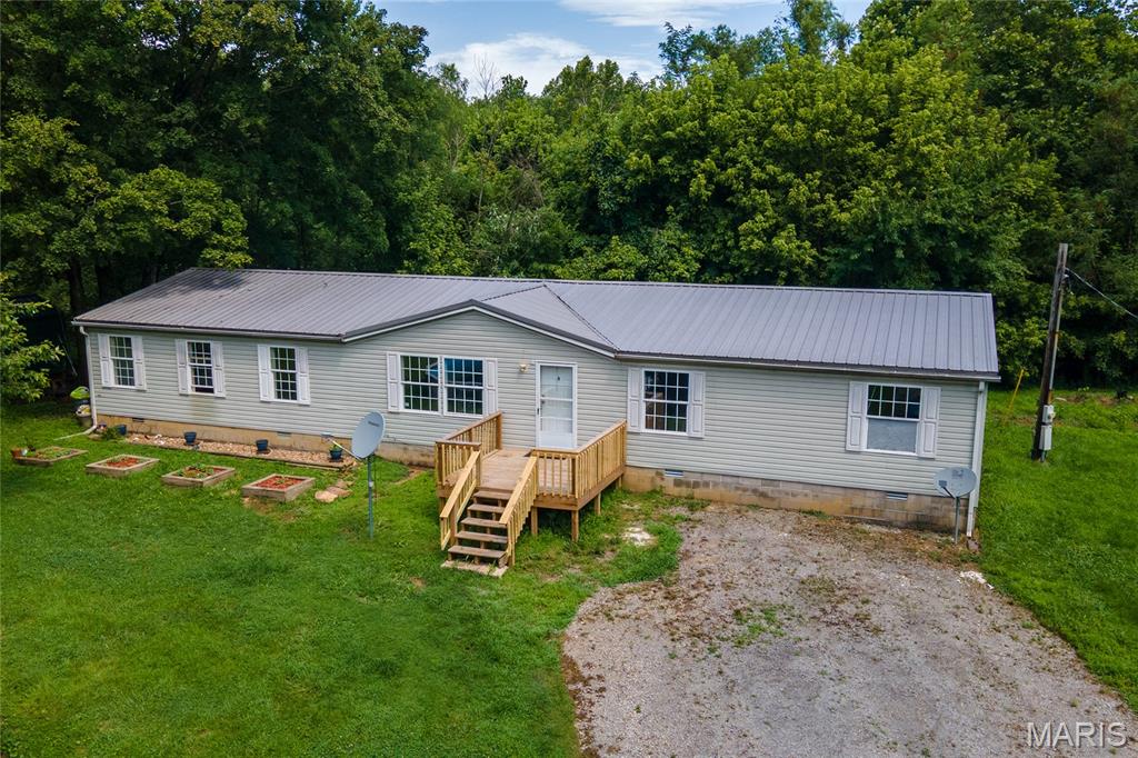 Escape to the peace and privacy of country living with this spacious 4-bedroom, 2-bath home nestled on 10 beautiful acres, most of which is wooded—perfect for hunting, hiking, ATV riding, or simply enjoying nature right outside your door. Tucked away at the end of a dead-end road, this property offers the seclusion you've been looking for while still being within a convenient drive to town.
Inside, you'll find a functional layout with generous living space for family and guests. Outside, the durable metal roof provides lasting value and low maintenance, while the surrounding acreage offers endless possibilities for recreation, gardening, or creating your own private retreat.
