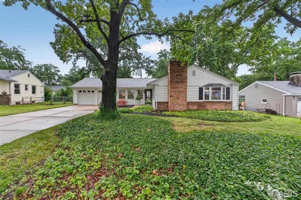 ATTACHED OVERSIZED TWO CAR GARAGE!
Welcome to this beautifully appointed ranch home in Kirkwood, where timeless charm meets thoughtful updates. The entry opens into an expansive family room featuring brand-new luxury flooring and built-in display shelving. Filled with natural light, the inviting living room is anchored by a gas fireplace, creating a warm and elegant gathering space.
The dining area showcases a bay window and a breakfast bar that seamlessly connects to the kitchen. The kitchen is equipped with updated stainless steel appliances, including a built-in Whirlpool microwave with convection and air fryer modes, a new Kohler sink and disposal, and a built-in gas stove and oven, all set in classic white cabinets. 
On the main level, you will find a generously sized primary bedroom, two additional bedrooms, and a main bathroom updated with a new Kohler toilet, plumbing fixtures, and a newer  Kohler walk-in shower. You will appreciate the refinished hardwood floors throughout the main level.
Downstairs, the partially finished lower level features new carpeting, a wood-burning fireplace, and a fully updated half bath with a new vanity and toilet, and ample storage. Fresh interior paint and new lighting on the main level enhance the home’s refined yet contemporary appeal. An oversized attached two-car garage adds both convenience and exceptional value.
Outdoors, a deck just off the kitchen and an expansive patio create an ideal setting for effortless entertaining and everyday enjoyment. Enjoy a level, fenced-in backyard perfect for endless activities! A newer Amana dryer and washer are also included. Newer Hwh
R-40 insulation is installed to help keep your utility bills reasonable. With mature trees, you will also appreciate the professionally installed gutter guards for ease of maintenance. 
Top-rated Kirkwood Schools, minutes from Highway 40/64, train station,  The Performing Arts Center,Magic House, Farmers Market with shopping, restaurants nearby