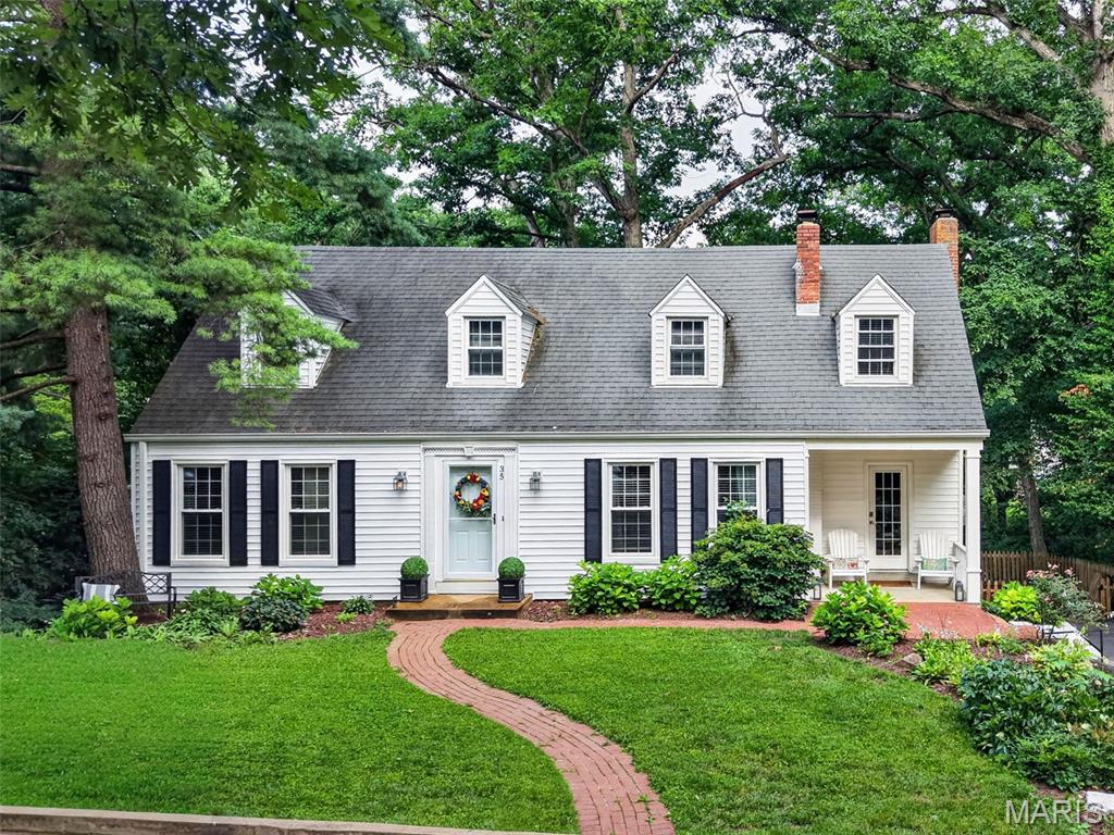 Classic Kirkwood charm meets peaceful wooded privacy! Nestled on a beautifully landscaped lot in one of Kirkwood's most sought-after neighborhoods, this inviting 4-bedroom, 2-bath home offers timeless character, flexible living space, and an incredible setting that feels like your own private retreat.

Step inside to discover beautiful hardwood floors, spacious living areas, two fireplaces, and an easy-flowing floor plan designed for everyday living and entertaining. The main-level primary bedroom provides exceptional convenience, while three additional bedrooms upstairs offer plenty of room for family, guests, or home office space.

The updated kitchen features stainless steel appliances, abundant cabinetry, and opens to a breakfast area overlooking the spectacular backyard. A separate family room with fireplace creates a warm gathering place, while the formal living room offers additional entertaining space.

Outdoors is where this home truly shines. Enjoy morning coffee or evening gatherings on the expansive deck overlooking mature trees and a serene wooded backdrop. Below, the covered stone patio creates another inviting outdoor living area surrounded by nature. The walk-out lower level offers excellent storage and future finishing possibilities.

Located in the highly acclaimed Kirkwood School District and just minutes from parks, shopping, restaurants, and everything Kirkwood has to offer, this is a rare opportunity to own a home that combines classic style, flexible living space, and an exceptional natural setting.