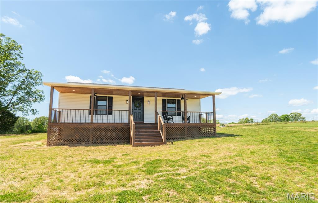 Tucked away on Ripley Route B in the peaceful Fairdealing community, this newly constructed 3-bedroom, 2-bath home blends modern comfort with timeless rustic charm. From the moment you arrive, you'll notice the inviting setting - surrounded by open skies and scenic views of neighboring pastureland that create a sense of space and tranquility.

Step inside to discover a thoughtfully designed layout with fresh finishes, warm textures, and an easy flow perfect for both everyday living and entertaining. The home offers a comfortable balance of style and functionality, with spacious bedrooms, a well-appointed kitchen, and inviting living areas filled with natural light.

One of the standout features is the beautiful covered front porch, complete with ceiling fans - an ideal spot to unwind, sip your morning coffee, or relax in the evening while taking in the peaceful surroundings. The large yard provides plenty of room to roam, garden, or simply enjoy the outdoors.

For those seeking even more opportunity, an additional residence with acreage may also be available for purchase alongside this property, offering flexibility for extended family, rental potential, or expanded living space. This is a rare chance to enjoy quiet country living with the benefits of new construction and room to grow.