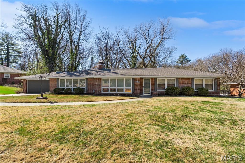 Welcome to 207 Country Club Lane, where comfort, space, and convenience come together in this well-maintained, move-in ready ranch. This full brick home offers a sprawling layout with two large living spaces, perfect for both everyday living and entertaining. A see-through fireplace creates a warm focal point between the living areas, while the original built-in in the family room and hardwood floors adds timeless character and charm. Fresh paint throughout most of the interior and updated light fixtures provide a clean, modern feel while still preserving the home’s classic appeal. Featuring 3 bedrooms and 2 full bathrooms, this home also includes a large laundry room that adds to the overall functionality. The attached oversized two-car garage offers ample space for parking and storage. Step outside to enjoy the screened-in porch, an ideal spot to relax with your morning coffee or unwind in the evenings. With its solid construction, thoughtful layout, and desirable setting, this home is a fantastic opportunity for buyers seeking space, character, and move-in readiness.