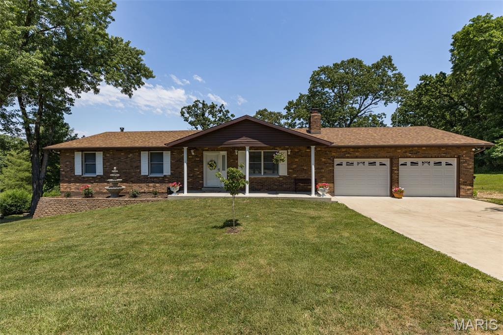 Meticulously maintained  all brick 3 bedroom and 3 full bathroom home in the highly sought after R-7 school district. Hurry to see this one! Enter the home to a large living room with beautiful gas fireplace. Large kitchen with lots of cabinets and counter top space- nice large pantry and room for eat-in breakfast table- separate large dining room- center hall plan has large full bathroom, large bedrooms 2 and 3 and a very nice primary bedroom with full bathroom. Off the dining room you walk out to the gorgeous large deck overlooking that big back yard! So much space to entertain or relax and enjoy the end of street privacy! The oversized 2 car attached garage has ample space for those long trucks and still have a nice workbench area too- back inside head down to the finished lower level with beautiful living room/rec room- the fireplace here is wood burning-can be converted to gas- another full bathroom- laundry and storage room too! A very nice walk out to the back yard that has also been nicely maintained- this home is perfect-come see for yourself!