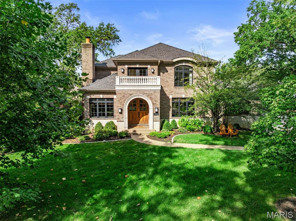 Built by RJ York Development in 2010, this Clayton Gardens gem showcases thoughtful architectural details and conveniences often overlooked in new construction. With a full masonry exterior and no tuck-under garage cutting into the LL, this 1.5-story, 5-bedroom, 4.5-bath home offers both substance and style. Ideally positioned on one of Clayton Gardens’ premier streets, the lot is more generous than most and within easy walking distance to all that Clayton has to offer. The layout balances everyday living with spaces perfect for entertaining. A barrel-vaulted entry with travertine floors leads to hardwoods, arched doorways, and elegant formality. The center-island kitchen opens to the breakfast and hearth rooms, where a stone fireplace creates warmth and access to a new deck. Formal gatherings are elevated by a dining room with a coffered ceiling and living room with fireplace. The main-floor primary suite offers a large walk-in closet, spa-like bath, and adjacent study with a masonry fireplace. A main-floor laundry/mudroom adds everyday ease. Upstairs, two bedrooms share a Jack-and-Jill bath, complemented by a third en suite bedroom. The finished LL expands living with a fifth bedroom suite, family and recreation rooms, media room, and generous storage. This home combines timeless craftsmanship with modern function, delivering a rare opportunity in one of the area’s most sought-after neighborhoods. 3 car main level garage with EV chargers.