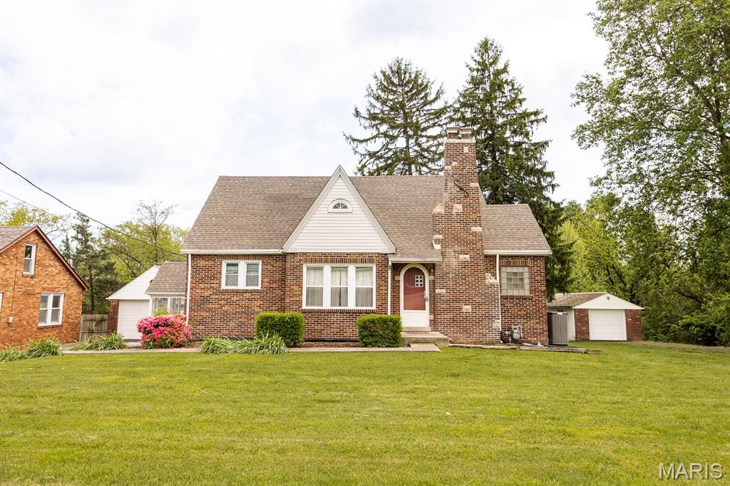 FULL OF CHARACTER AND TIMELESS APPEAL, THIS ALL-BRICK COTTAGE STYLE HOME SITS ON A BEAUTIFUL ONE-ACRE LOT OFFERING SPACE, PRIVACY AND CHARM. Fresh paint throughout and hardwood flooring on the main level. The kitchen features maple cabinets and offers a large dining space. You will love drinking coffee in the coxy three-seasons room perfect for relaxing or entertaining. With four bedrooms, two full baths there is plenty of space to grow. The unfinished lower level provides space for storage. Two driveways and two detached garages offer ample parking plus there is a workshop in one of them. Major updates include NEW roof, HVAC components, water heater and furnace. A unique property that blends charm, updates and space-just minutes from everything while still offering a private, peaceful setting. Close to restaurants and interstate access. A brand new aeration system was installed 05/2026. Home is being sold AS-IS, seller to make no additional repairs.