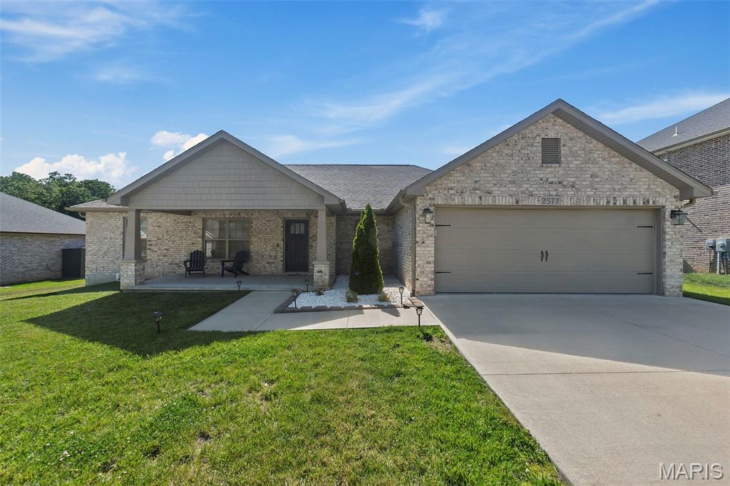 Some homes are designed to simplify life — and this one does it beautifully. Built in a newer community with modern finishes and a practical one-level layout, this home offers the kind of convenience buyers increasingly search for but rarely find. There are no steps from the attached 2-car garage into the home, making transporting groceries, hosting guests, and even moving in safer and easier. Inside, the open-concept layout feels airy and connected without sacrificing warmth. Vaulted ceilings, rich flooring, granite countertops, abundant cabinetry, and a large gathering island create a space that functions just as comfortably for quiet evenings as it does for entertaining family and friends. Patio doors extend the living area outdoors to a covered patio overlooking the backyard, while the covered front porch offers another inviting place to sit and unwind. The primary suite is thoughtfully positioned away from the additional bedrooms for added privacy and features a spacious walk-in closet, whirlpool tub, separate shower, and dual vanity. One feature especially meaningful in Southeast Missouri is the dedicated safe room — a valuable addition during storm season that offers peace of mind many buyers wish they had before they need it. Modern, low-maintenance, functional, and move-in ready — all without HOA restrictions.