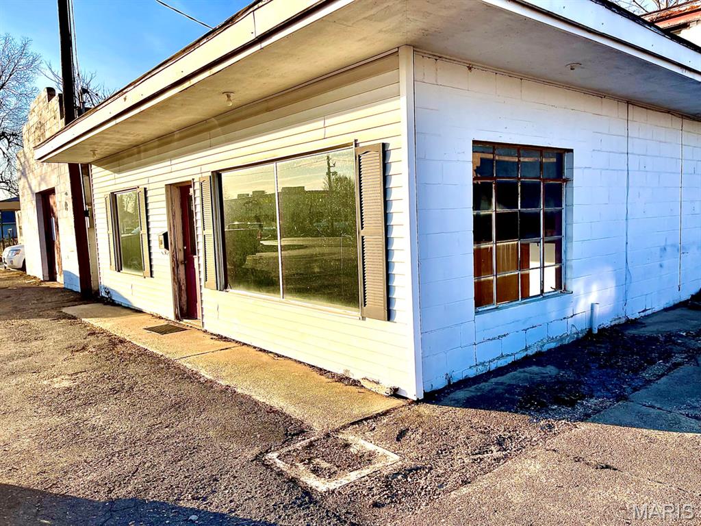 Excellent investment opportunity featuring a 9,248 sq ft multi-use building located in the town’s business area with strong visibility and accessibility. Building includes an 864 sq ft second floor apartment (apartment needs some renovation). Additional improvements include: 1 house-3bdrm,2 bath,1350 sq ft; a 2nd house-840 sq ft, 2 bedrooms, 1 bath; and a vacant lot. Ideal for investors, business owners, or redevelopment projects. Prime location with multiple income streams and upside potential.