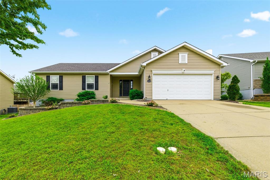 Welcome home to this beautifully updated ranch in Moscow Mills offering 3 bedrooms, 2 full bathrooms, and 1,347 sq ft of thoughtfully designed living space! From the moment you arrive, you’ll appreciate the professional landscaping, oversized garage with rear bump-out, and inviting curb appeal. Step inside to newer laminate flooring throughout the main living areas, fresh carpet in the bedrooms, and a spacious vaulted living room featuring a cozy woodburning fireplace with a stunning wood mantle.

The kitchen is both stylish and functional with espresso staggered cabinets with crown molding, under-cabinet lighting, granite countertops, tile backsplash, stainless steel appliances, updated sink and fixtures, and a charming farmhouse light fixture over the dining area. Sliding glass doors lead to the large backyard patio and incredible fire pit area—perfect for entertaining or relaxing evenings outdoors.

The laundry room is conveniently located off the kitchen and garage and features custom wood molding, hooks, and plenty of shelving for extra storage. The vaulted primary suite is a true retreat with a custom accent wall, walk-in closet with built-ins, and a show-stopping primary bathroom featuring a custom tile shower with luxury spa shower system and double-width vanity. Secondary bedrooms offer fresh paint, newer carpet, and ceiling fans, while the second full bath includes a unique moon skylight for added natural light.

The unfinished basement includes an egress window and full bath rough-in, offering endless potential for future living space, a rec room, additional bedroom, or home office. This home blends comfort, style, and functionality inside and out—don’t miss your chance to make it yours!