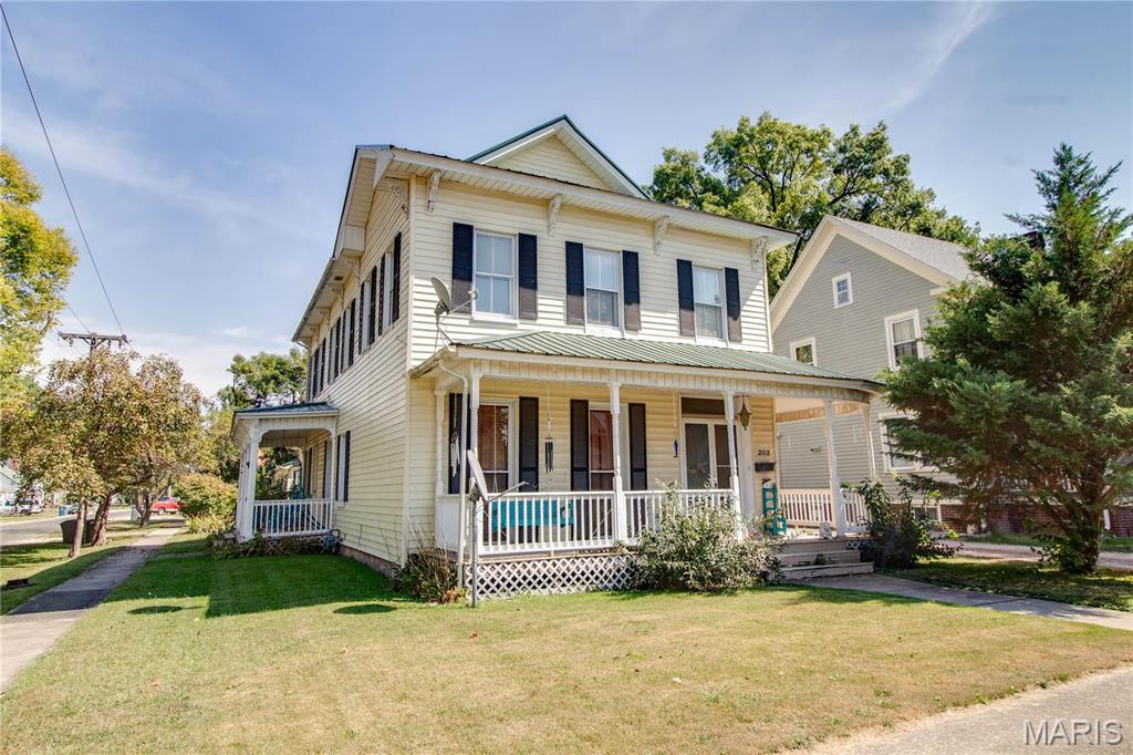 Step into this beautiful home located in the quaint but thriving town of Carrollton Illinois. This home features some gorgeous millwork and extremely detailed features throughout, such as a large kitchen with attached laundry and bathroom, the wrap around porch, beautiful front door leading to the decadent staircase up to the second floor with a pedestal tub bathroom. This property is located within a short distance of the downtown square for all of the amenities such as shopping, dining, entertainment, and so much more. There is a detached 2 car garage with a workshop area and a portable shed as well. This home has so many possibilities and is just waiting for a new owner.