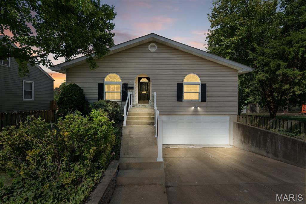Perfect for multi-generational families, roommates, savvy investors, or really anyone seeking a spacious single-family home that offers a unique, flexible layout setting it apart from others. Built in 2000 and meticulously maintained, this residence is move-in ready and features recent upgrades, including fresh paint and new carpeting throughout. The home’s design seamlessly accommodates dual-living arrangements. The lower level offers convenient, no-step entry directly from the 2-car garage, leading to a complete, self-contained living space that includes a kitchen, living room, full bathroom, bedroom, and private walkout access to the fully fenced backyard.The main level is equally impressive, featuring: Custom Chef’s Kitchen: Equipped with stone looking finish counters and an eat-in breakfast bar, new range, and tile back splash. A large, sunlit family room flows into the dining area, which opens via sliding glass doors to a spacious rear deck. Two generous bedrooms, two full bathrooms, and main-level laundry ensure functional, comfortable living. The current owner has prioritized maintenance, including a recently updated sump pump system for total peace of mind regarding the lower level. Situated in a charming, quiet neighborhood, the property offers the best of both worlds: a serene retreat that is still under 15 minutes from downtown entertainment, nearby restaurants, and shopping. This is a rare opportunity to own a newer home with exceptional versatility and income potential. Schedule your private showing today.