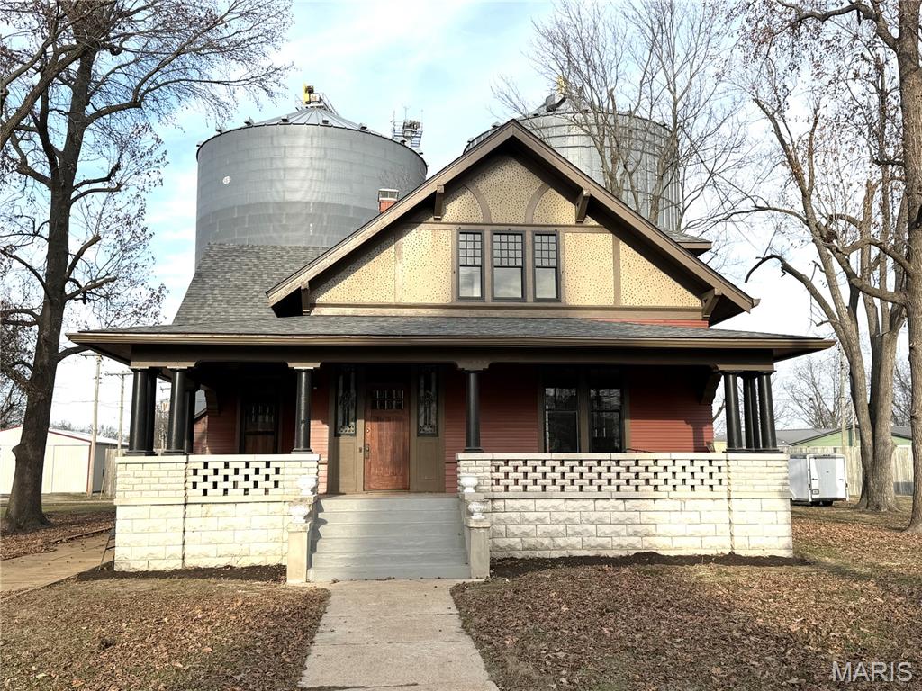 Discover timeless charm and modern updates in this stunning home in Addieville! The Bohbrink House features a  large front entry foyer welcoming guests with original woodwork, stained glass window, open staircase and wood floors. The same quality finishes carry into the family room, formal dining room and office. Totally updated kitchen including new cabinets, counter tops, ceramic flooring and appliances. On the second floor you will find wide hallways, 3 generous sized bedrooms, a full bath and spacious laundry room. Some other updates include a new roof on the home in 2023, all plumbing, all electrical, all baths, insulation in walls and attic, dual HVAC and ductwork. There is a 3 season room and large wrap around front porch for outdoor entertaining.