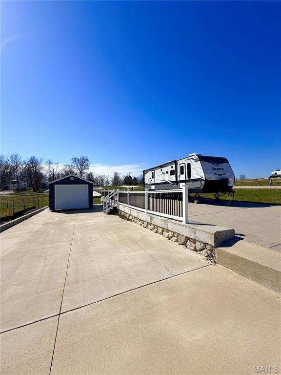 AMAZING CAMPING RETREAT AT MARK TWAIN LAKE!! Check out this Beautiful RV lot in Adventure Out RV Park! Bring your RV and enjoy this peaceful lot close to all the amenities at the lake. Jellystone Park, the Cannon Dam, Blackjack Maria and Spaulding Beach are all just minutes from the RV park. Lot 85 is 0.115/acre and has TWO large concrete pads measuring approximately, 80' x 22' each, perfect for your camper and multiple vehicles.  This lot has vinyl fencing dividing the two concrete pads and a large patio area for family gatherings!  The park is very clean and well maintained! Private fishing pond available to all lot owners!  Why lease, when you could own your own lot! Call today to make this your new getaway at the lake! What are the costs for your lake getaway? HOA is $200/year for 2026. RV park bills for Electric, Trash and Sewer. You pay your own water and internet. Take the main entry road into Adventure Out RV Park (Look for directional sign). Once you enter the park, turn on the first drive to the left, then take the first right . Lot 85 will be the last lot on the right.  Shed is NOT included with this sale, but can be purchased separately.    Call today for your private showing.