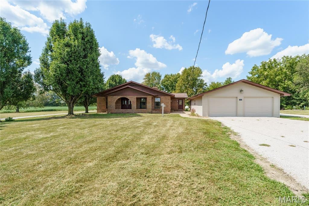 Welcome to this all-brick home situated on 1.27 acres, offering plenty of space both inside and out! The main level features 3 bedrooms, including a spacious primary bedroom with its own private bathroom, a large living room, kitchen, dining room, and convenient main-floor laundry. The finished basement adds even more living and entertaining space with a large family room, second kitchen/bar area, office area, and an additional full bathroom—perfect for entertaining, working from home, hobbies, or additional living space. Outside, enjoy the privacy and possibilities that come with 1.27 acres, along with an oversized 2-car garage and additional shed for lawn equipment, tools, and storage. Several major updates have already been completed, including a roof in 2020, hot water heater in 2023, and HVAC system in 2025. With its solid brick construction, generous room sizes, finished lower level, multiple living spaces, acreage, and major recent updates, this home has so much to offer. Come see all the space and possibilities this wonderful property provides!