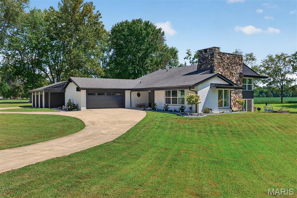 Stunning Mid Century Modern design on 2.83 acres of lakefront property! Completely renovated inside and out, this exceptional 6 bedroom, 4 bath home combines timeless character with modern amenities in a park like setting. The extensive renovation includes new energy efficient doors and windows, exterior painting and low maintenance siding. Two new hvac systems were installed, updated plumbing inside and out, new interior doors and trim, all new lighting fixtures, The completely updated kitchen features new cabinetry, quartz countertops, glass tile backsplash, pot filler and GE Cafe appliances.  Kitchen opens to an inviting hearth room with wood burning fireplace and a triple sliding door to the back yard that lets in abundant natural light.  Large storage room behind the fireplace could be used as a walk-in pantry. Primary suite offers a lake view, dressing area and updated bath with deep soak tub, walk-in shower, double vanity and a bidet toilet. All bedrooms are spacious with generous sized closets.  Plenty of room for vehicles and toys in either the attached 2 car garage and an adjacent 32x32 3 car garage, both with new doors and garage door openers. Floors in kitchen, dining, family and hearth rooms have an epoxy finish. 28 ft. round pool is one year old and includes all equipment.  Great fishing in your own back yard!  This is truly a one of a kind home in a serene location!   One of the listing agents is related to the sellers.