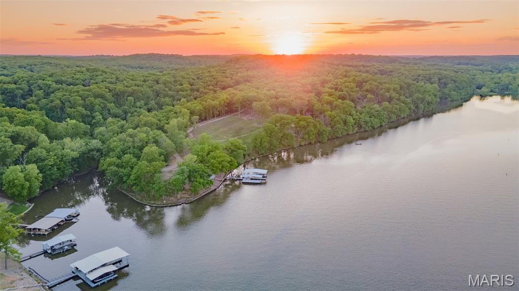 This is an opportunity you do not want to miss! It is truly the last of its kind in the area. This property boasts a move-in ready home along with terrific views of your 117 +/- continuous acres on the banks of the Lake of the Ozarks with over 4,000 feet of shoreline. This opportunity is great for the individual, investor, or developer. It is perfectly located in a qualified opportunity zone in Sunrise Beach, Missouri. The opportunities are major and the area of the property is unique. Here you get a quiet setting while still being close to many popular destinations in the lake area and on the water. Located at the 39 ½ mile marker. Its topography is ideal for just about anything you can imagine, from development to personal enjoyment. From building multiple homes,venturing into a resort-style development, or simply enjoying your very own private retreat, the possibilities here are endless. With much more to learn and see that this property offers schedule your private tour today!