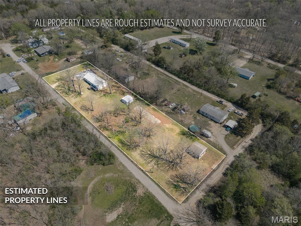 BACK ON MARKET AT NO FAULT TO SELLER - CONTRACT WAS CONTINGENT UPON THE SALE OF BUYER'S HOME THAT NEVER HAPPENED!  This listing consists of 8, level lots in Lake Timberline, a private well and septic, and usable outbuildings.  The house is currently uninhabitable due to a fire.  When viewing the property, no one is allowed to access the home.  This transaction is to remain AS-IS.