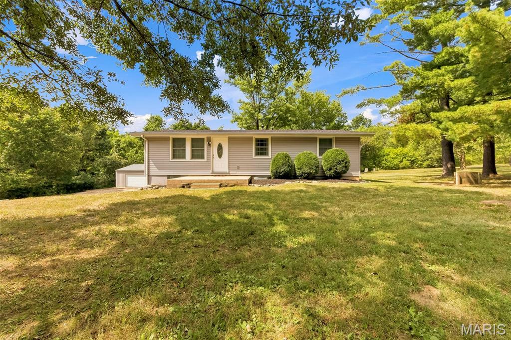 Enjoy peaceful country living on approximately 2+/- tree-lined acres in Lincoln County! This inviting 3-bedroom, 3-bath ranch offers a spacious open floor plan with beautiful hardwood flooring and vaulted ceilings that create a bright, welcoming atmosphere. The kitchen features a center island with plenty of space for meal prep, casual dining, and entertaining while flowing seamlessly into the main living areas. The walk-out lower level is partially finished and provides additional living space with a large recreation room, full bathroom, spacious utility room, and plenty of storage. Step outside and relax on the covered patio overlooking the private, tree-lined property. A standout feature is the impressive 50x30 pole barn with electric, offering abundant space for equipment, vehicles, recreational toys, a workshop, or additional storage. With approximately 2 acres, mature trees, generous indoor and outdoor space, and a versatile outbuilding, this Lincoln County property offers the perfect combination of comfortable living and room to enjoy the outdoors.