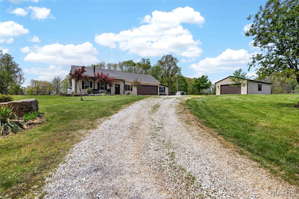 BACK ON MARKET with a BRAND NEW ROOF! 10 acres and views of a beautiful quarry. A TRUE one of a kind you MUST see! A private oasis awaits at the back of a low density street with no HOA and surrounded by mature timber and tons of wildlife. 2 car attached garage features an 8' door and extended workshop area, AND a LOFT for a home office or additional sleeping area as well as a 4 car 40x24 detached garage! Gives you plenty of room to store all of your vehicles, equipment, and SxS's! This stick built 3 bed / 2 bath home has been recently updated throughout and impeccably maintained. You're welcomed into a spacious open concept floor plan with 10' ceilings, wood burning fireplace with decorate stone accent, surround sound, and tons of natural light. Expansive kitchen features 42" solid cherry cabinetry, tiled backsplash, granite counter tops, and large island with breakfast bar. Custom bar area featuring hand cut red oak beams and craftsman style light fixtures and vintage glass window. Expansive master suite features an updated master bath with dual vanity and tiled walk-in shower with dual shower heads. Enjoy an expansive covered rear patio overlooking your grounds with ceiling fans, lighting and electric hookups for smokers and fridges. Perfect for entertaining large groups of friends and family. Let's not forget the above ground saltwater pool. No basement? No problem! The entire length of the home is full of storage in the attic. Perfect for all of your extras! You don't see these properties come on the market often. Don't let this one slip away, schedule your private showing today!
