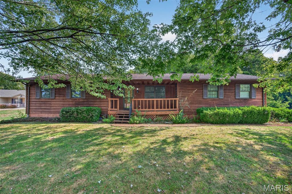 Highland School District with easy access to I-70 for commuters!   Affordably priced, 1 story,  3 bedroom, 2 bath cedar sided home will need some cosmetic updates. Selling as is, seller will not make repairs.  Side entry attached garage plus a 768 sq ft detached garage and workshop with a lean to on the back. Mature trees on the property and lot backs up to open ground. Main floor bathroom has been updated with a walk in shower.  There is a wood burning furnace in the basement that has not been used in several years.  Kitchen includes appliances and a snack bar counter that opens to a large dining area with atrium doors out to a 10 x 14 deck overlooking the private back yard. So much potential if you are willing to do some updating to make it your own!
