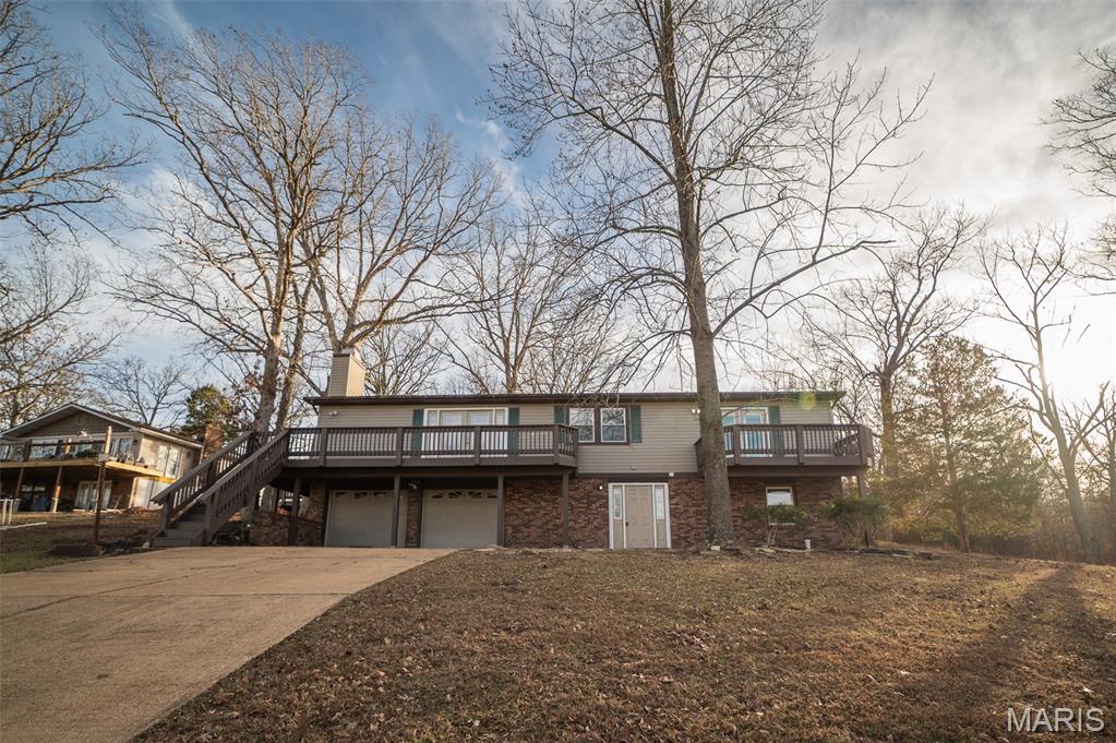 Back on market! No fault of seller! Buyer failed to perform! Beautifully refreshed 3 bed, 3 bath ranch with 2,425 sq ft of finished living space and a 2-car tuck-under garage. This spacious lake retreat features fresh paint, new flooring, and tasteful updates throughout. The large front deck offers stunning lake views—perfect for morning coffee or evening relaxation—while the covered rear porch provides a peaceful, shaded escape. The open floor plan and ample living space make this home ideal for entertaining or quiet weekends away. Whether you're looking for a full-time residence or a weekend getaway, this home delivers comfort, style, and unbeatable views.