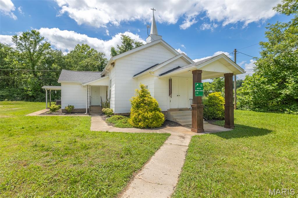 Step into a piece of local history with this charming church, originally built in 1893, tucked away just off PP Highway among quiet gravel roads and grassy fields. Rich with character and timeless appeal, this unique property offers endless possibilities for its next chapter. A welcoming foyer opens into the spacious main gathering area, where rustic wood beams and an oversized chandelier create a warm atmosphere. Previously operated as both a church and an event center, this property is well-suited for continued use as a church, event venue, daycare, community center, or could even be reimagined as a one-of-a-kind residence or Airbnb with a little TLC. Beyond the main hall, you'll find several additional rooms that offer storage, potential bedroom or office space, and an area that could be converted into a kitchen. Two separate bathrooms provide added convenience, while multiple entrances, including wheelchair-accessible access, make the property functional for a variety of uses. Recent renovations such as a new roof in 2021 and updated central heat/air offer added assurance, while outside the artesian well adds extra interest and charm!
Whether you're searching for a unique investment opportunity, a historic venue, or a property ready to bring your vision to life, this distinctive church offers character, versatility, and endless potential in a peaceful rural setting.