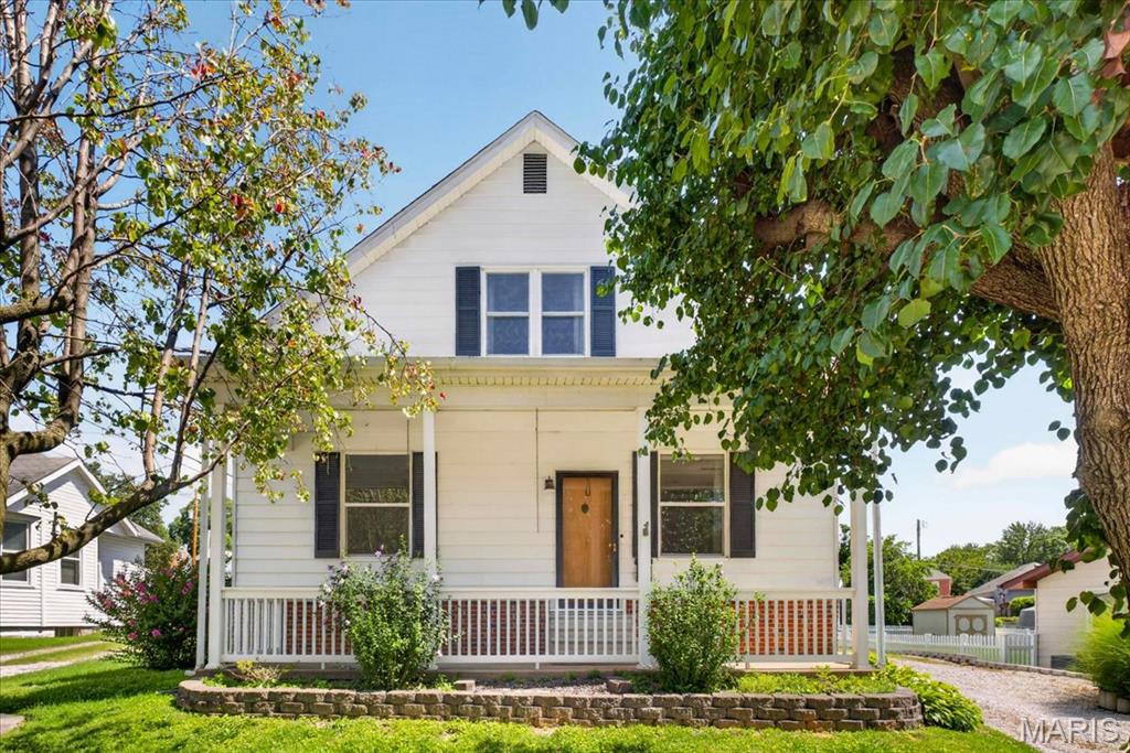 Charming 3 bedroom, 2 bath 1.5-story home in the heart of Columbia with ~1800 sq. feet finished. Lovingly maintained, this home blends timeless character with exceptional potential. A full, covered front porch welcomes you with peaceful views and is perfect for enjoying quiet mornings or warm summer evenings. Around the back, you’ll find a detached 2-car garage, fully insulated with heater, overhead door & ample storage space and very private back yard with mature trees that provide lots of shade AND the driveway has AMPLE parking space, even for an RV!
 Enter the front door to find High ceilings, tall baseboards, original doors, beautiful woodwork and original plaster walls that add to the nostalgic charm throughout the home.  The front door, with transom window, opens to the open spindle staircase in the formal living room.  To your left is the generously sized living room provides the perfect backdrop for holidays and gatherings. Make your way to the flex space where you can have a formal dining room, home office space or maybe a play area. Next you will find the Main floor full bath with Pedestal Sink, Tub/Shower and Two Closets.  
The extra large eat in kitchen features tons of solid oak cabinets, newer flooring,  white appliances including refrigerator, dishwasher, range & microwave, tile backsplash and soaring 10 ft ceilings. 
Upstairs, a spacious landing makes an inviting reading nook, Primary bedroom with Two Closets, Large Windows and Built In Shelf, Two nicely appointed bedrooms with built in storage and 1 with a walk-in closet and full hall bath with shower, vanity, and storage closet.  
The unfitted lower level houses the laundry area, mechanicals, workshop area, and plenty of space for storage.
Located in the heart of Columbia, this home offers small-town charm with easy access to local shops, parks, and restaurants.  This is a wonderful opportunity to create a space where you can Live Where You Love!