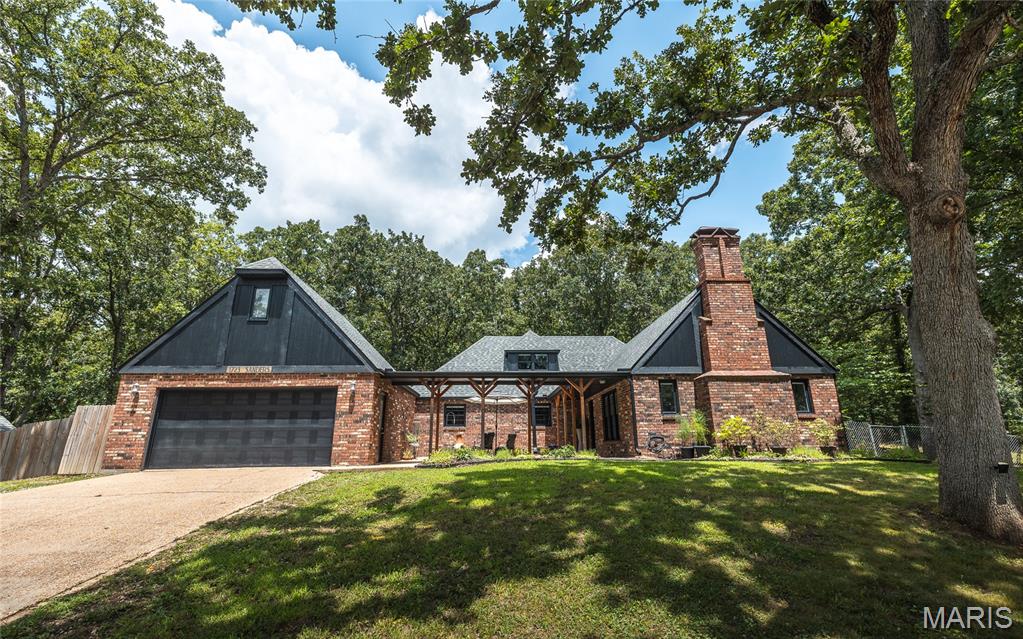 Welcome home to 1723 Sanders Rd, Waynesville, MO! This full brick 4-bedroom, 2-bath 1.5 story home is tucked away on over an acre lot in one of Waynesville's most peaceful, secluded neighborhoods. From the moment you arrive, you'll be charmed by the front courtyard and covered walkway that create a warm, magazine-worthy first impression. Inside, thoughtful design meets everyday functionality with custom built-in cabinetry just inside the entry, providing the perfect drop zone for coats, shoes, and bags. The oversized dining room easily accommodates large gatherings of family and friends and flows seamlessly into the spacious remodeled kitchen, complete with a nook for a coffee bar and an additional dry bar, which offers an extra pantry and storage space. The living room provides a cozy place to unwind and opens directly to the backyard, making indoor-outdoor living effortless. Three generously sized bedrooms and a beautifully updated full bath with an elegant vanity complete the main level, while built-in shelving adds charm and convenience to one of the bedrooms. And don't miss the Harry Potter closet under the stairs! Upstairs, you'll find a private retreat featuring a flexible office or sitting area that leads into the spacious primary bedroom and full bath. A bonus room offers endless possibilities, whether you envision the ultimate walk-in closet, dressing room, nursery, hobby space, or private retreat. Additional highlights include an attached garage with a separate bonus room above—perfect for hobbies, a workshop, studio, or extra storage—a large backyard shed, and a charming greenhouse ready for gardening enthusiasts. Offering privacy, character, and room to grow both inside and out, this one-of-a-kind property is ready to welcome you home. Schedule your private showing today! Ask about the additional lot across the street if you need additional room to spread out!