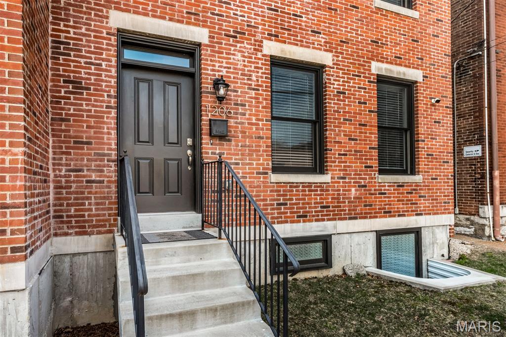 Love historic Soulard but worry about the upkeep of a 100+ year-old home? This stunning 4-year-old home offers the charm of the neighborhood with the comfort, efficiency, and ease of newer construction.  Designed for entertaining and everyday luxury, this home is loaded with thoughtful upgrades. The kitchen and all baths feature quartz countertops, while the dreamy primary suite offers heated bathroom floors, an oversized custom closet, a heated towel rack, and a private deck with hot tub for the ultimate retreat. A spacious second-floor laundry room provides abundant storage, and all three generously sized bedrooms feature their own private baths.  The finished lower level offers incredible flexibility with a bedroom that could easily serve as a home theater, gaming room, or guest suite. The kitchen is a chef’s delight with two pantries and KitchenAid Professional Series appliances. A built-in bar, wiring for flat screens, and even a bonus slot machine (for entertainment only) make this home ready for fun. 3 Levels of living.   Enjoy Soulard’s vibrant lifestyle with parks, restaurants (Foodies' dream), nightlife, and the beloved Community of Gardens all just a stroll away. Located in a golf cart-friendly neighborhood, getting around is part of the fun. Solar panels help significantly reduce power costs, while the attached garage with epoxy floors, gutter guards, window screens, and an installed security system add even more convenience.  A large lower-level storage room with utility sink offers endless possibilities for an indoor garden, artist studio, or workshop. With easy interstate access and an unbeatable combination of style, comfort, and low-maintenance living, this is a rare Soulard find.